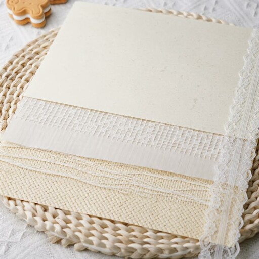 Colorful textured paper sheets displayed creatively on a desk.