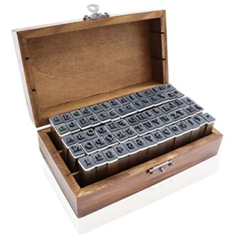 Alphabet stamp set in a wooden box with lid open.