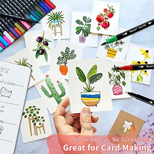 A collection of hand-drawn plant and fruit art pieces surrounded by markers and pens, ideal for card making.
