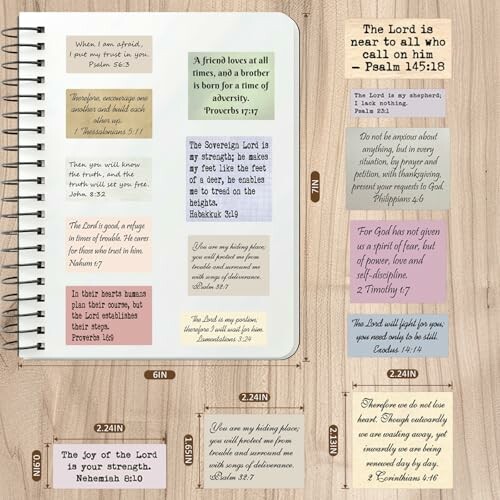 Notebook with various Bible verses on a wooden table.