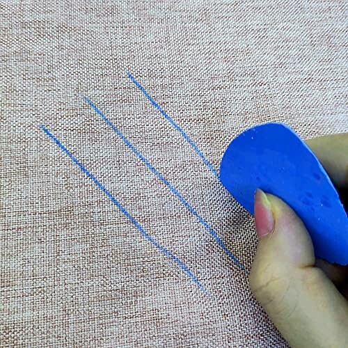 Blue tailor's chalk drawing lines on fabric.