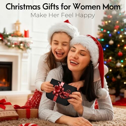 Mother and daughter in Santa hats enjoying Christmas gift.