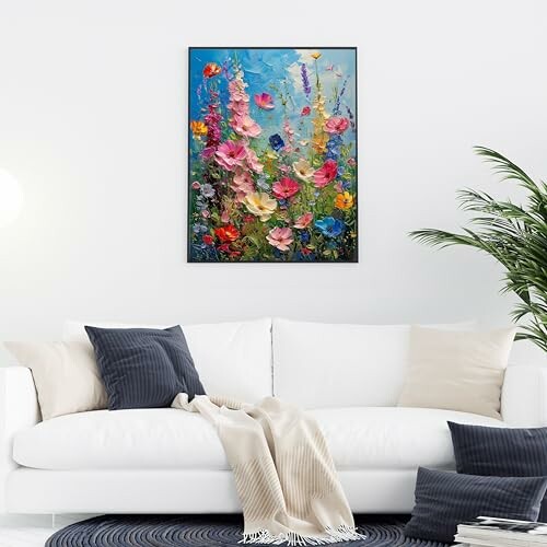 Colorful floral painting above a white sofa with cushions.