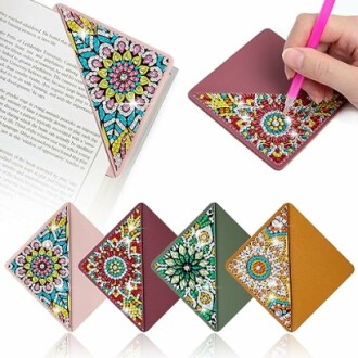 Colorful mandala pattern corner bookmarks, with a hand using one on a book.