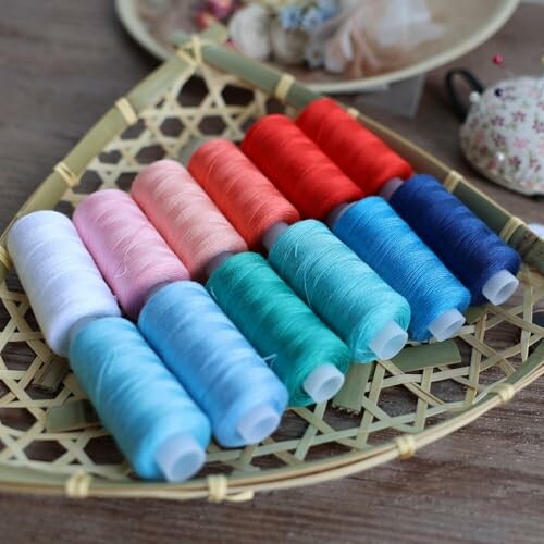 Assorted colorful thread spools on a woven tray.