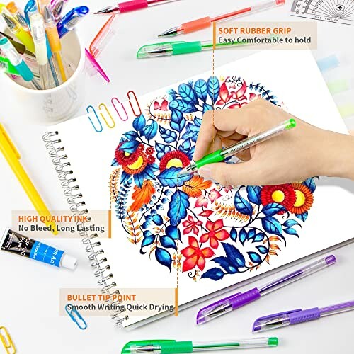 Person coloring intricate floral design with colorful pens and art supplies.