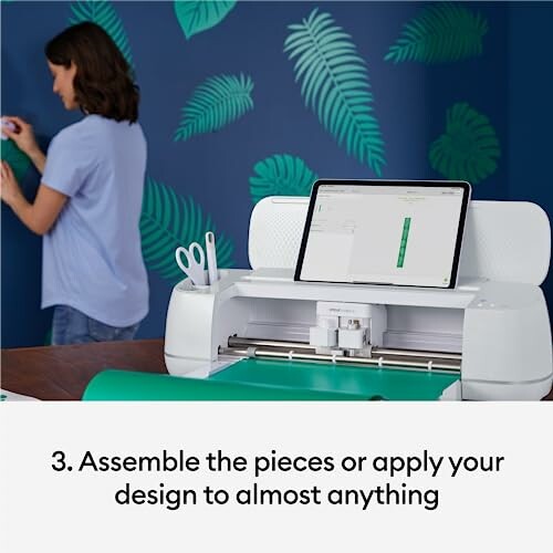 Crafting machine with tablet and woman applying wall decals.