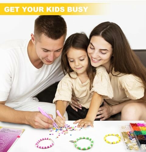 Family making bead crafts together at a table.