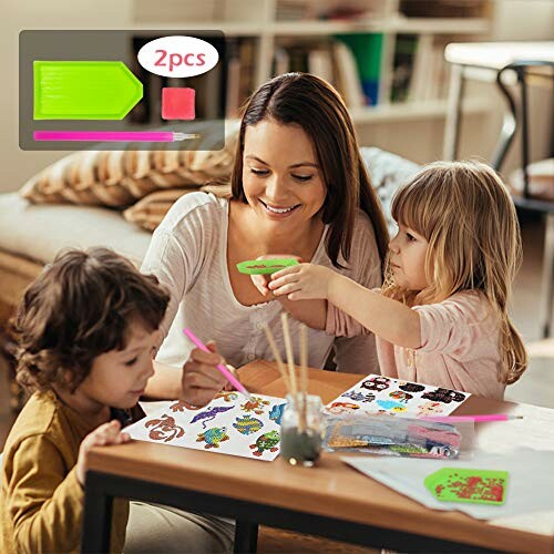 A mother and two children engaging in a diamond painting activity at a table.