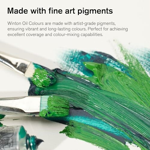 Brushes with green paint on canvas, highlighting fine art pigments.
