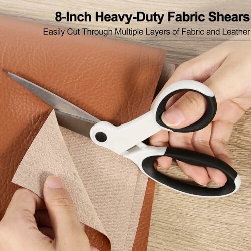 Hands using 8-inch heavy-duty fabric shears to cut fabric and leather.