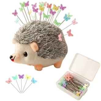 Hedgehog pin cushion with colorful butterfly pins and storage box.