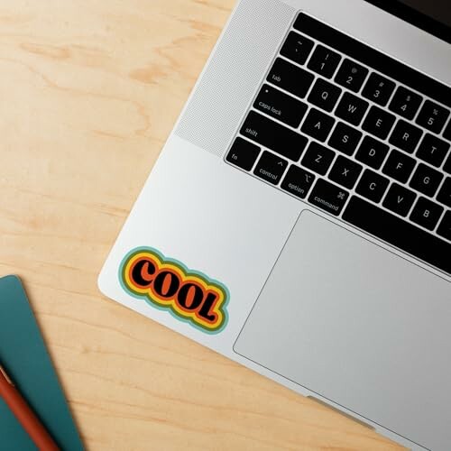 Laptop with a 'COOL' sticker on the corner.