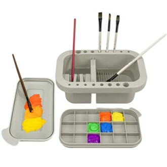 Paint brush holder with paints and palette.