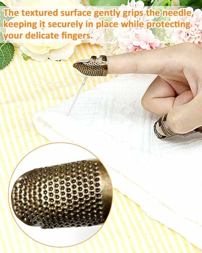 A person using a metal thimble on their finger while sewing fabric with a needle.