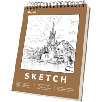 Spiral-bound sketchbook with a cover illustration of a village and church.