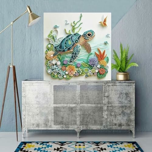 Colorful turtle wall art above a metal cabinet with a lamp and plant.