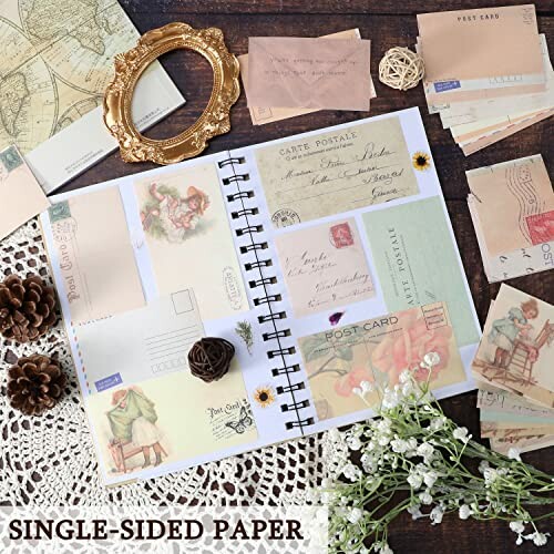 Collection of vintage-style scrapbook materials including postcards, paper, and decorative items.
