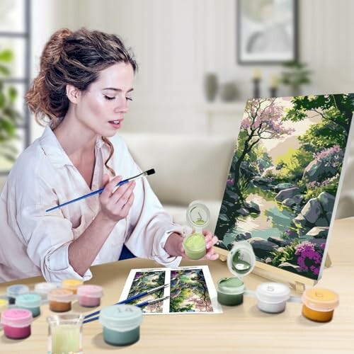 Woman painting a nature scene with art supplies.